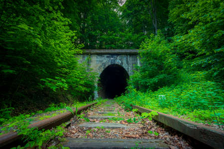 Historic railway tunnel under the mountain. Former German engineering construction currently out of...