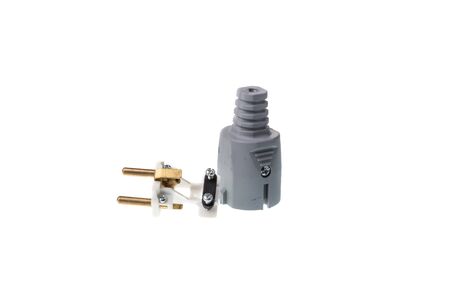 Disassembled gray ac power plug with two pins and ground, isolated on white backgroundの写真素材
