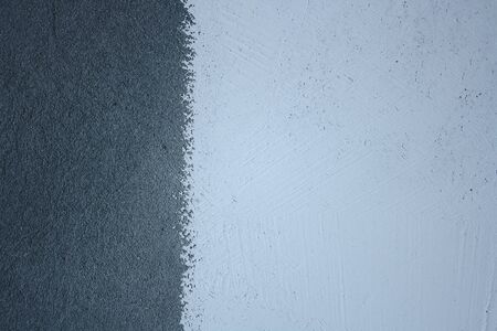 Close-up of a white putty applied to a gray concrete wall. Abstract background for illustrations.の写真素材
