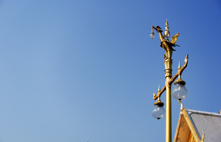 Light pole gold swan and blue sky and The temple roof in thailandの写真素材
