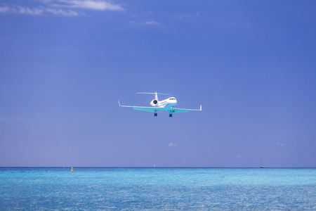 Airplane landing Over Caribbean Seaの写真素材