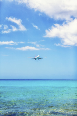 Airplane landing Over Caribbean Seaのeditorial素材