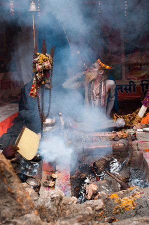 BABUGHAT, KOLKATA, WEST BENGAL   INDIA - 9TH JANUARY 2013   A Sadhu  Hindu Saint  smokes on 9th January, 2013 at Babughat, Kolkata  Every year many Sadhus from all over India reaches Babughat on their way to reach Gangasagar  Sagar  to bathe there  Gangasのeditorial素材