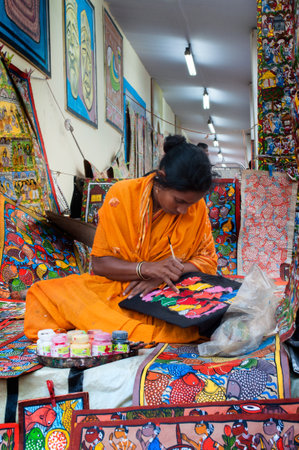 KOLKATA, WEST BENGAL , INDIA - DECEMBER 14TH 2013   Unidentified woman painting Artworks of handicraft, at Handicraft Fair in Kolkata - the biggest handicrafts fair in Asia のeditorial素材