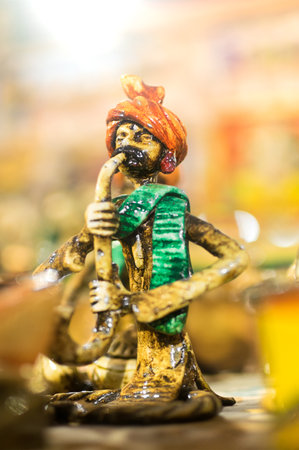 KOLKATA, WEST BENGAL , INDIA - NOVEMBER 23RD 2014 : Terracotta doll, snake charmer,  handicraft on display during Handicraft Fair in Kolkata - the biggest handicrafts fair in Asia.のeditorial素材