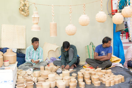 KOLKATA, WEST BENGAL , INDIA - DECEMBER 12TH 2014 : Unidentified persons making Cane furnitures , handicrafts on display during the Handicraft Fair in Kolkata - the biggest handicrafts fair in Asia.のeditorial素材