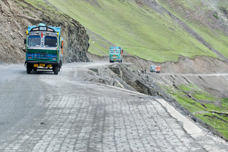 LEH, INDIA - SEPTEMBER 1, 2014 : Trucks carrying goods are passing through Zojila Pass, a high mountain pass between Srinagar and Leh at 11575 ft, 9 Km stretch. Indian National Highway.のeditorial素材