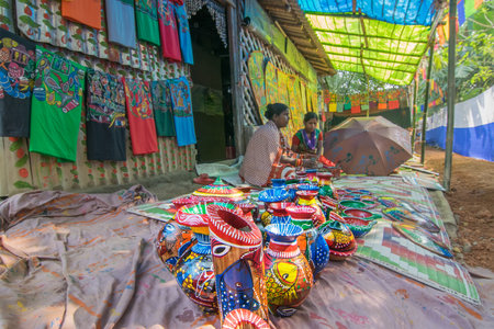 PINGLA, WEST BENGAL , INDIA - NOVEMBER 16TH 2015 : Colourful handicrafts are being prepared for sale in Pingla village by Indian rural woman worker. Handicrafts are rural Industry in West Bengal.のeditorial素材