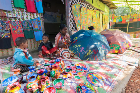 PINGLA, WEST BENGAL , INDIA - NOVEMBER 16TH 2015 : Colourful handicrafts are being prepared for sale in Pingla village by Indian rural woman worker. Handicrafts are rural Industry in West Bengal.のeditorial素材
