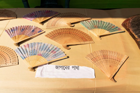 PINGLA, WEST BENGAL , INDIA - NOVEMBER 16TH 2014 : Woodmade handicrafts , Japanese fans, are being sold at Pingla village. Handicrafts are very popular and a big industry in West Bengal, India.のeditorial素材
