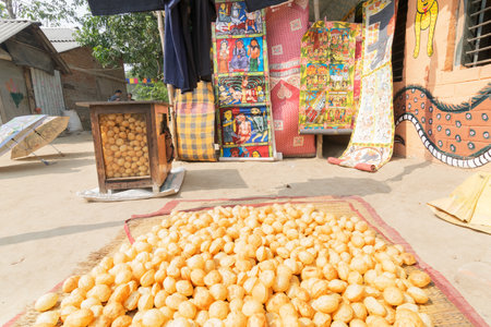 PINGLA, WEST BENGAL , INDIA - NOVEMBER 16TH 2014 : "Futchka" - a street food found throuhout India, made of wheat flour, is being dried for sale at Pingla village.のeditorial素材