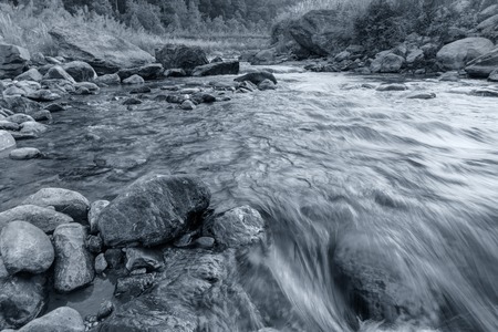 Beautiful Reshi River water flowing on rocks at dawn, Sikkim, India - a spectacular view , tinted...