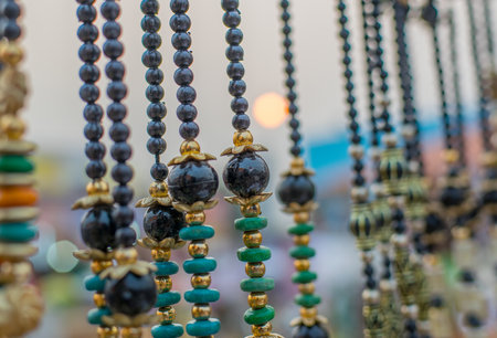 KOLKATA, WEST BENGAL , INDIA - NOVEMBER 28TH 2015 : Fashinable necklaces , artworks of handicraft on display under setting sun, at Handicraft Fair in Kolkata - the biggest handicrafts fair in Asia.のeditorial素材