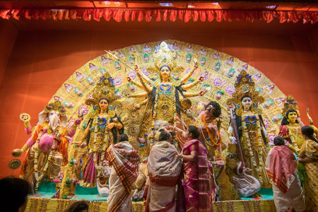 KOLKATA , INDIA - OCTOBER 18, 2015 : Married Bengali women worshipping Durga idol at Puja pandal,...