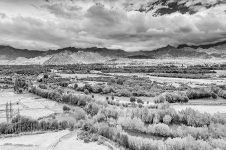 Aerial view of Leh City, green landscape with ice peaks , blue sky with clouds in background , Ladakh, Jammu and Kashmir, India. Black and white image.の写真素材