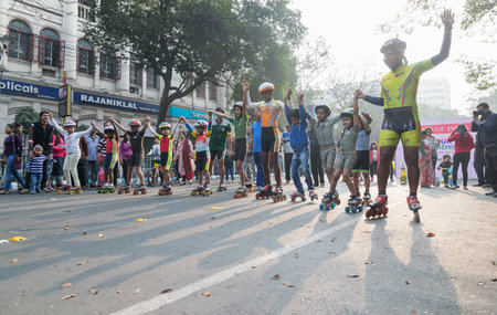 KOLKATA, WEST BENGAL, INDIA - JANUARY 17TH 2016 : Unidentified city children rollerskating on blocked, otherwise busy,Park Street for "Happy Street" event. Children played, enjoyed and had fun.のeditorial素材