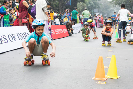 KOLKATA, WEST BENGAL, INDIA - JANUARY 17TH 2016 : Unidentified city children rollerskating on blocked, otherwise busy,Park Street for "Happy Street" event. Children played, enjoyed and had fun.のeditorial素材