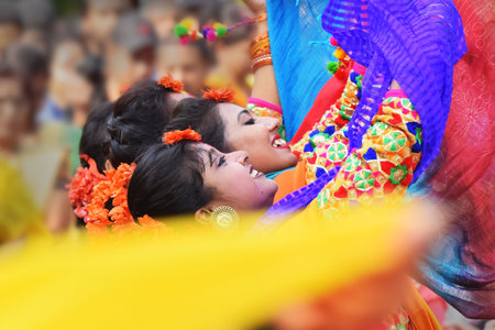 KOLKATA , INDIA - MARCH 12, 2017: Young girl dancers joyful dance at Holi/Spring festival,known as Dol (in Bengali) or Holi (in Hindi) celebrating arrival of Spring in India. Popular Indian festival.のeditorial素材