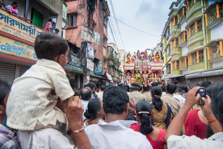 KOLKATA, WEST BENGAL , INDIA - 12TH AUGUST 2012 : Religious Hindu devotees pulling ropes of procession Lord Ram. Ram is a Hindu God, based on whose life, epic story "Ramayana" was written thousand of years ago.のeditorial素材