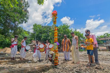 HOWRAH, WEST BANGAL,INDIA - JULY 7TH, 2017 : khutipuja, the starting ritual of world famous Durga Puja, (most famous festival of Hinduism), is being performed by a Hindu devotees with dhakis performing behind.のeditorial素材
