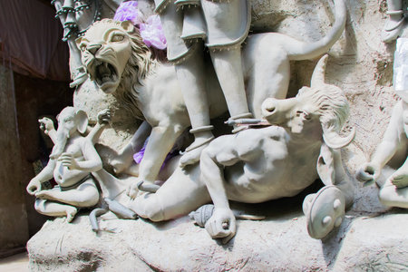 KOLKATA, WEST BENGAL, INDIA - 25 SEPTEMBER 2016: Artist preparing Clay idol of Asura, the demon, killed by Goddess Durga, forのeditorial素材
