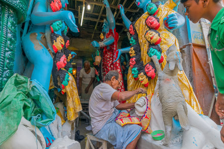 KUMARTULI, KOLKATA, INDIA - OCTOBER 10, 2014 - Artist preparing clay idol to be worshipped as Goddess Kali, during Kali Puja, Hindu festival of Deepavali or Diwali. Celebtated all over India.のeditorial素材