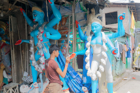 KUMARTULI, KOLKATA, INDIA - OCTOBER 10, 2014 - Artist preparing clay idol to be worshipped as Goddess Kali, during Kali Puja, Hindu festival of Deepavali or Diwali. Celebtated all over India.のeditorial素材