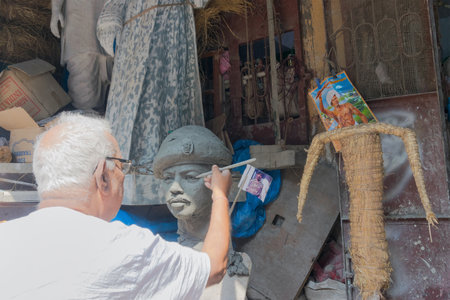 KUMARTULI, KOLKATA, INDIA - OCTOBER 10, 2014 - Artist preparing clay idol of a soldier.のeditorial素材