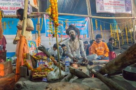 BABUGHAT, KOLKATA, WEST BENGAL / INDIA - 9TH JANUARY 2018 : Gathering of Indian Hindu Sadhus , singing religious songs at Gangasagar transit camp. Shot at colored light in winter night.のeditorial素材