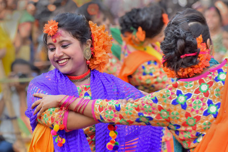 KOLKATA , INDIA - MARCH 12, 2017: Young girl dancers joyful dance at Holi/Spring festival,known as Dol (in Bengali) or Holi (in Hindi) celebrating arrival of Spring in India. Popular Indian festival.のeditorial素材