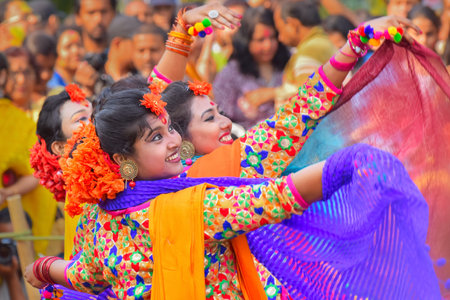 KOLKATA , INDIA - MARCH 12, 2017: Young girl dancers joyful dance at Holi/Spring festival,known as Dol (in Bengali) or Holi (in Hindi) celebrating arrival of Spring in India. Popular Indian festival.のeditorial素材