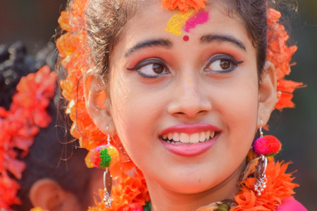 KOLKATA , INDIA - MARCH 12, 2017: Portrait of girl dancer, dressed in sari (traditional Indian dress) and Palash flowers (Butea monosperma) make up, dancing at Dol (in Bengali) or Holi (in Hindi).のeditorial素材