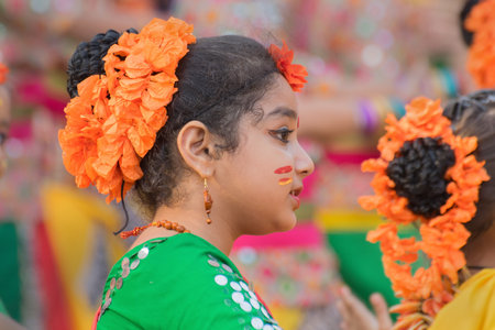 KOLKATA , INDIA - MARCH 12, 2017: Girl dancers, dressed in sari (traditional Indian dress) and Palash flowers (Butea monosperma) make up, dancing at Dol (in Bengali) or Holi (in Hindi) festival.のeditorial素材