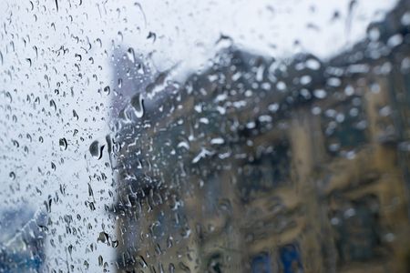Raindrops falling on glass, abstract blurs - monsoon stock image of Kolkata (formerly Calcutta) city , West Bengal, Indiaの写真素材