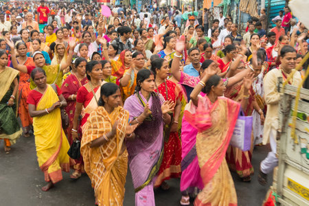 KOLKATA, WEST BENGAL , INDIA - JUNE 29TH 2014 : Women devotees dancing in front of God Jagannath, Balaram and Goddess Suvadra as ritual. Iskcon rath jatra festival.のeditorial素材