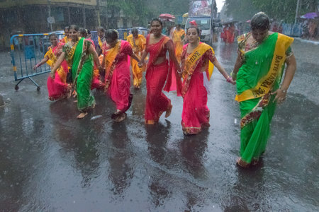 KOLKATA, WEST BENGAL , INDIA - JUNE 25TH 2017 : Rain soacked female devotees around Rath (chariot)...