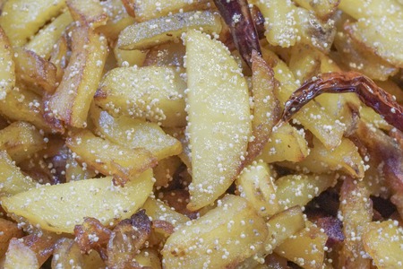 Close up image of fried potato pieces with fried red chilly - a fast food dish . Popular amongst Indians as a tasty snacks.の写真素材