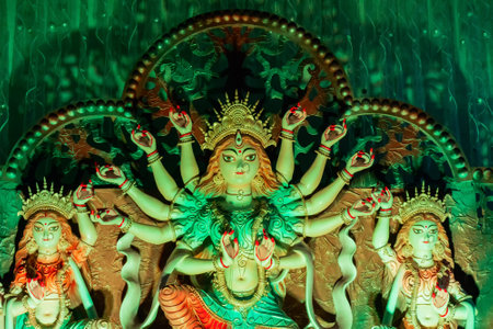 Goddess Durga idol at decorated Durga Puja pandal, shot at colored light, at Kolkata, West Bengal, India. Durga Puja is biggest religious festival of Hinduism and is now celebrated worldwide.のeditorial素材