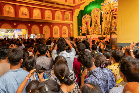 KOLKATA , INDIA - SEPTEMBER 29, 2017 : Devotees walking to pray to Goddess Durga idol inside decorated Durga Puja pandal at college square. Durga Puja is biggest religious festival of Hinduism.のeditorial素材