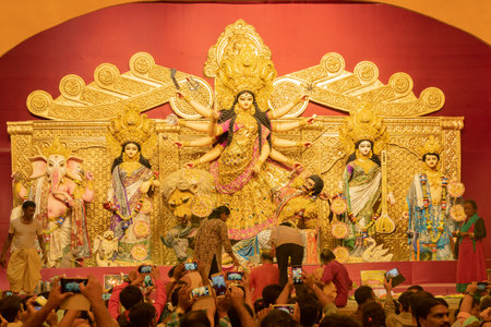 KOLKATA , INDIA - SEPTEMBER 29, 2017 : Goddess Durga idol inside decorated Durga Puja pandal, shot at colored light . Durga Puja is biggest religious festival of Hinduism.のeditorial素材