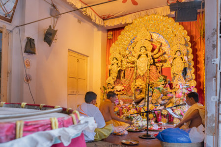 KOLKATA , INDIA - SEPTEMBER 28, 2017 : Hindu priests worshipping Goddess Durga inside a bengali house . Durga Puja is biggest religious festival of Hinduism.のeditorial素材