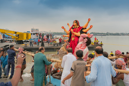 KOLKATA, WEST BENGAL, INDIA - 30 SEPTEMBER 2017: Idol of Goddess Durga is being carried to holy river ganges for immersion, calledのeditorial素材