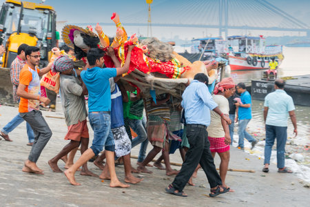 KOLKATA, WEST BENGAL, INDIA - 30 SEPTEMBER 2017: Idol of Goddess Durga is being carried to holy river ganges for immersion, calledのeditorial素材