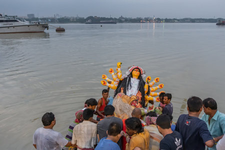 KOLKATA, WEST BENGAL, INDIA - 30 SEPTEMBER 2017: Idol of Goddess Durga is being carried to holy river ganges for immersion, calledのeditorial素材