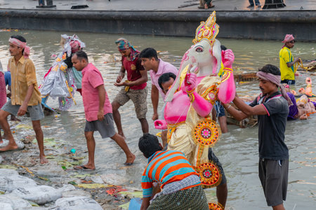 KOLKATA, WEST BENGAL, INDIA - 30 SEPTEMBER 2017: Idol of Lord Ganesha is being immersed in Holy river Ganges. Celebrated by Hindus asのeditorial素材