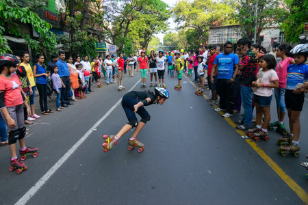 KOLKATA, WEST BENGAL, INDIA - MARCH 29TH 2015 : Girl rollerskating while others watch her skills ,...