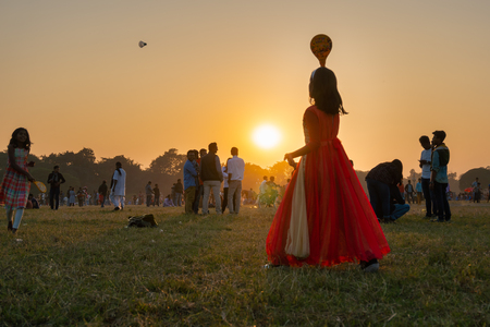 KOLKATA, WEST BENGAL, INDIA - DECEMBER 25TH 2017 : Indian girl playing badminton at Kolkata maidan during sunset. It is a place for many civilians to spend in winter afternoon.の写真素材