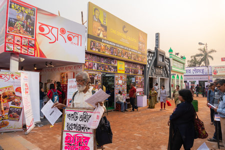 KOLKATA, INDIA - FEBRUARY 9TH , 2018 : Old man selling little magazines at Kolkata book fair, with...