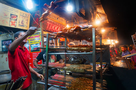 OLD MARKET, NEW DELHI, INDIA - OCTOBER 28 2018 : Spicy chicken seekh kababs are being prepared by men and being stacked on the road side for sale as street food. It is famous for various street foods.のeditorial素材