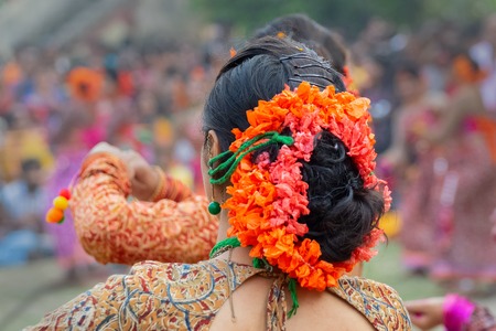 Flower make up on her hairs. Young girl dancer with Palash flower , Butea monosperma , on her hairs dancing at Holi Spring festival .の写真素材